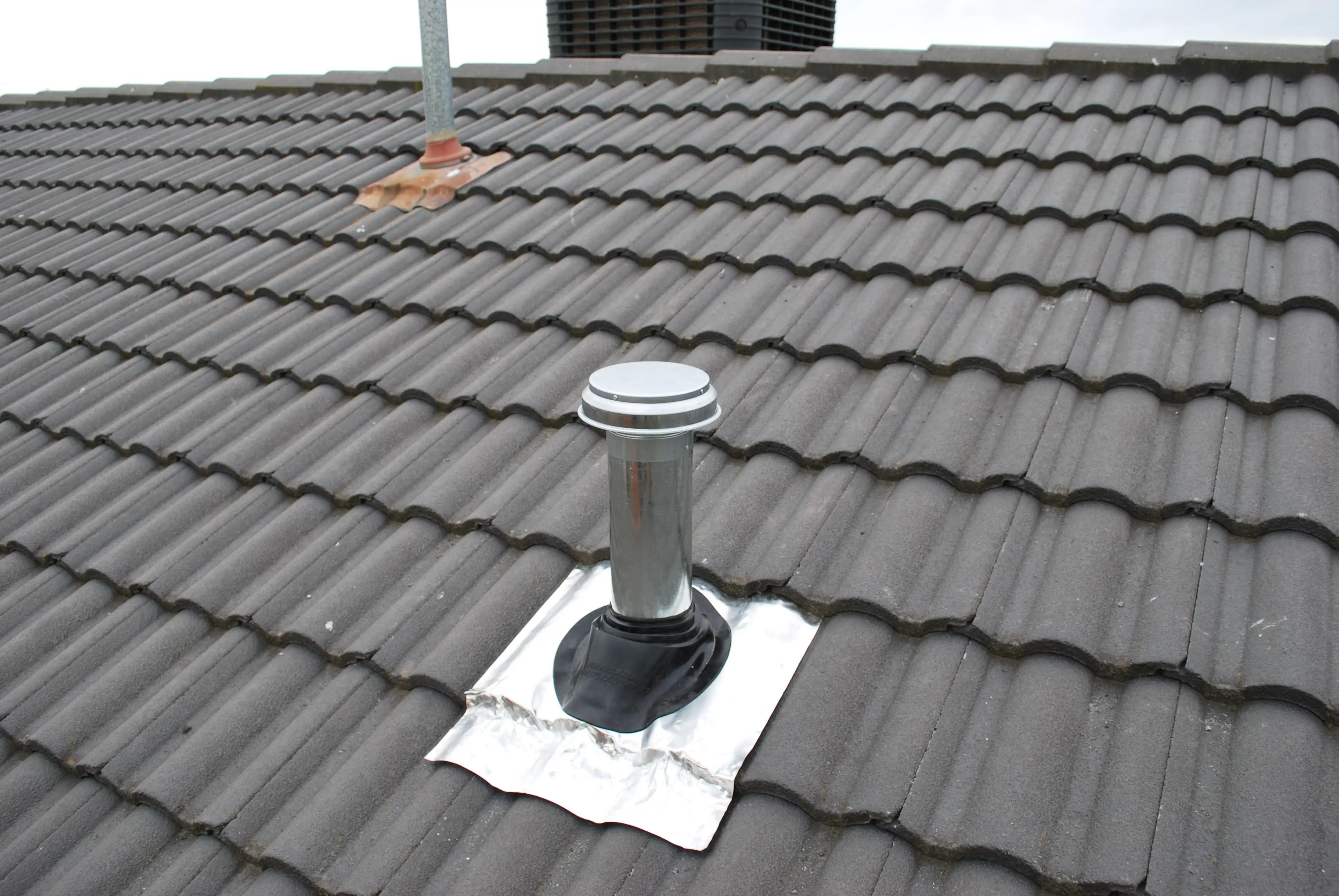 Install duct pipe to rangehood through the roof tiles 3