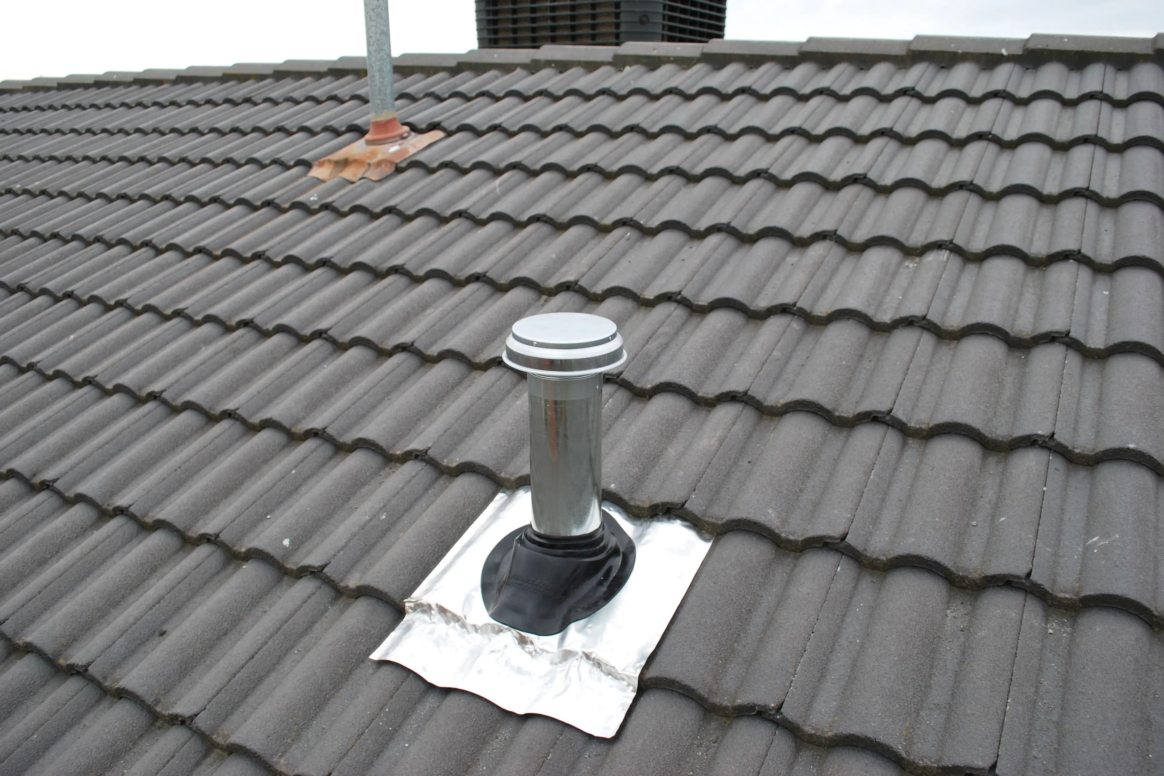 Install duct pipe to rangehood through the roof tiles 3