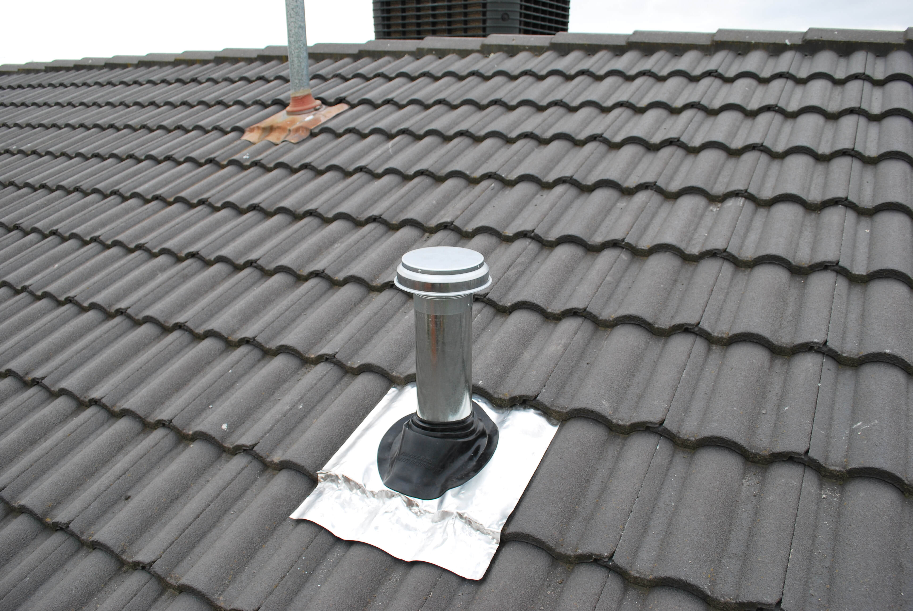 Install duct pipe to rangehood through the roof tiles 3